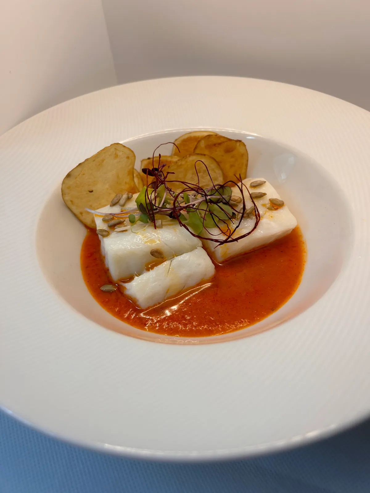 Cod with piquillo pepper and honey sauce and potato crisps, from the La Estrella 1924 menu