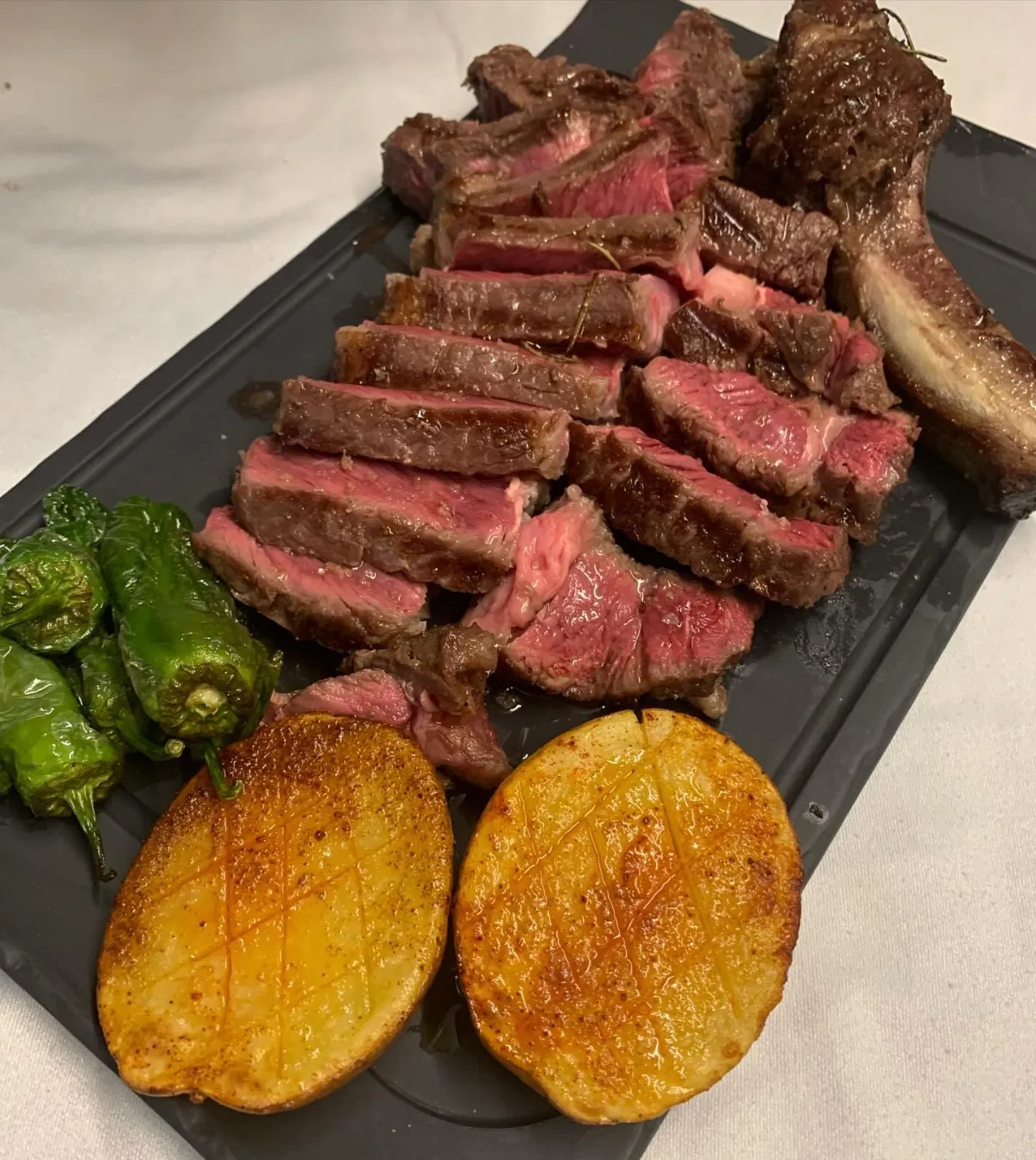 Beef rib steak with potatoes and Padrón peppers at La Estrella 1924