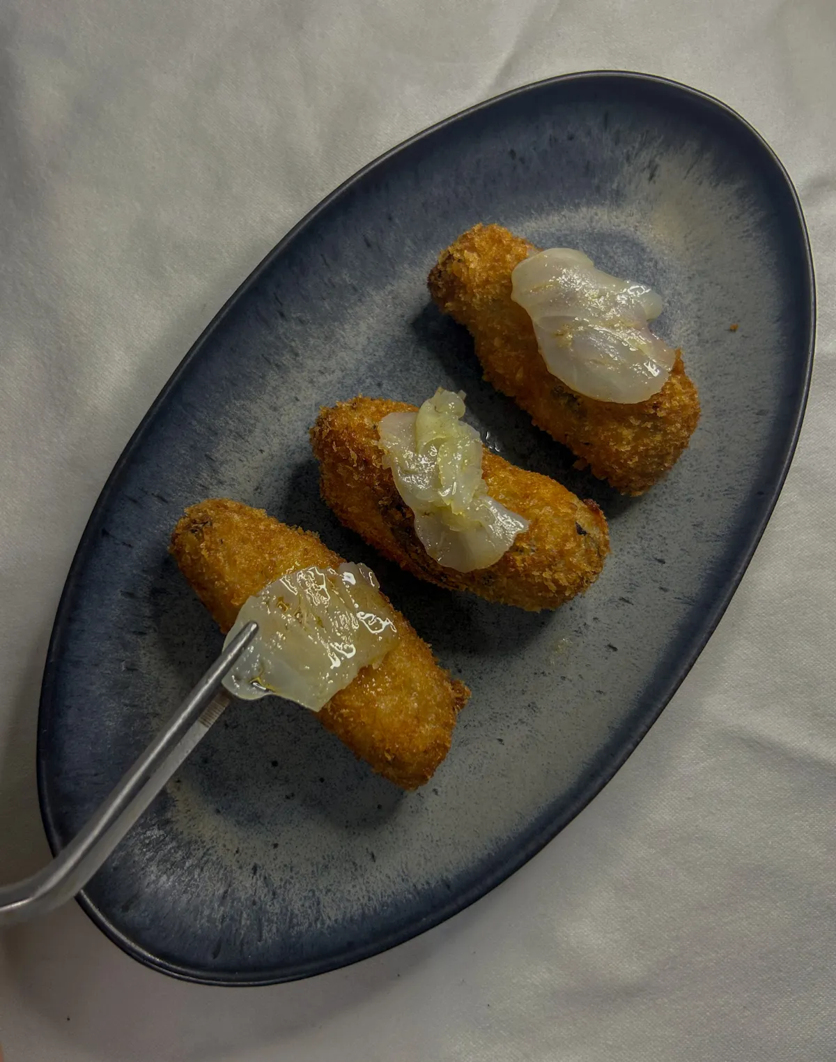 Crispy homemade croquettes on an oval platter