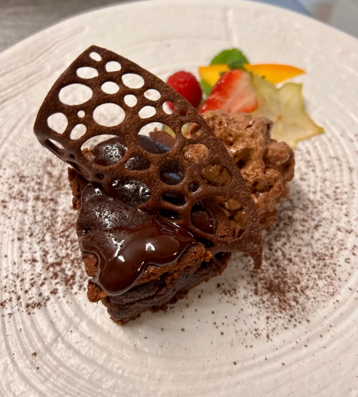Homemade chocolate dessert with a cocoa tuile, mousse and fresh fruit